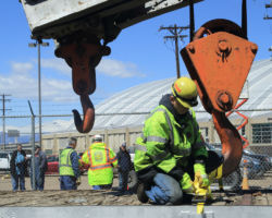 Securing the big hook just so it doesn't get to swinging during the trip.