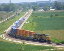 Seen from high above the mainline (and through the equivalent of a 480mm lens), UP 7515 leads a westbound stacker just west of Woodbine, IA. The mid-ninety-degree temps that day didn't help out with this one at all... This section from Denison to Missouri Valley was converted back to CTC-controlled double track in the late 1990s.