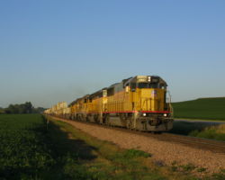Crossing through a bean field along US 30 just east of Kennard, NE, UP 5997 leads a westbound stack train in the late evening light.
