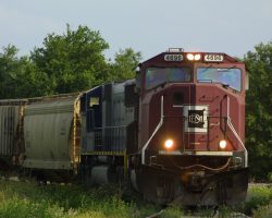 An all-burgundy EMD leads a loaded train from the south to north lines at Edison on 6-May.