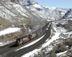 A Utah Rwy. coal train works uphill through Castle Gate, UT