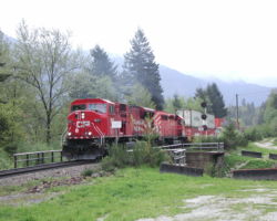 The first train of the day - CP 9127 (an SD90) leads an eastbound stack.