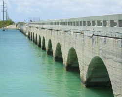 Kemp Channel, the first (driving north of Key West) of the arch bridges that doesn't still have the highway decking. The bridges that have had their highway deck removed now have concrete guard rails to allow them to be used as fishing piers. Also note the two missing bridge segments towards the far end to isolate the unimproved bridge segment.