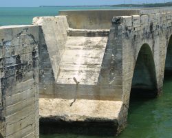 The underwater sections were poured using "German Cement", which apparently hardens underwater. Above water, these hollow arch structures were poured over a giant form and then filled with sand and gravel and covered by track and ballast, providing a water-permeable material that would drain rainfall away from the ties. One problem - where did it drain to?