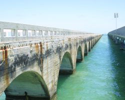 The opposite side of the bridge from the previous shot - note the new Seven Mile Bridge to the right, and note the drain holes at the bottom center of the arches. These drained the porous fill material. Also clearly visible is the dividing line between the underwater section of the pier and the pour for the arch.