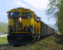 A loaded gravel train, lead by 4009 and 4011, sits near Palmer, AK, waiting behind another for permission to enter the main line. It's about 0830, and the northbound Denali Star hasn't cleared the Anchorage-Palmer Jct. section of the main yet.
