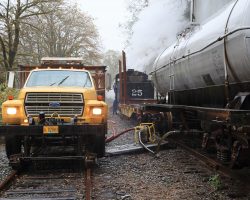 25's getting a little low on water, so we stop at Batterson in the pouring rain to pump water into the tender from the tank cars.