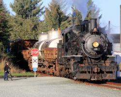 Approaching Wheeler, with one of the local kids out to meet the train.