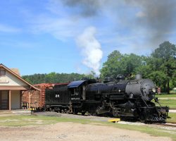 SPL 28 passes the Maydelle station - the only original station building on the line. Rails reached town in 1904.