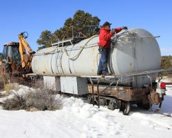Backing our extra water and a backhoe into the Big Horn wye and tying it down.