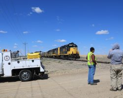 Two guys were running ahead of the train, checking the crossings and flagging (non-existent) traffic since most folks have probably forgotten there actually are trains out here occasionally. The guy in the grey hoodie is just Chip flying his drone around.