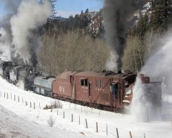 Out the other end of the narrows, the train starts to curve away from the road to climb up through the S-curve below Lobato