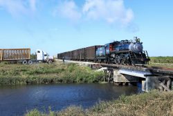 Highball over the Miami Canal while a cane truck waits (and probably wonders what these crazy people are doing)