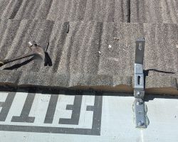 A freshly-installed anchor, showing how they attach under the metal roof