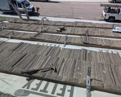 Lots of new anchor hooks for the rack, showing the roof with the metal shingles pulled up.