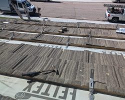 Lots of new anchor hooks for the rack, showing the roof with the metal shingles pulled up.