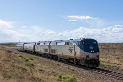 With the coal train through Avondale, the two Amtrak P42s and two extra cars get a green to head east. Seen coming into Boone, CO.